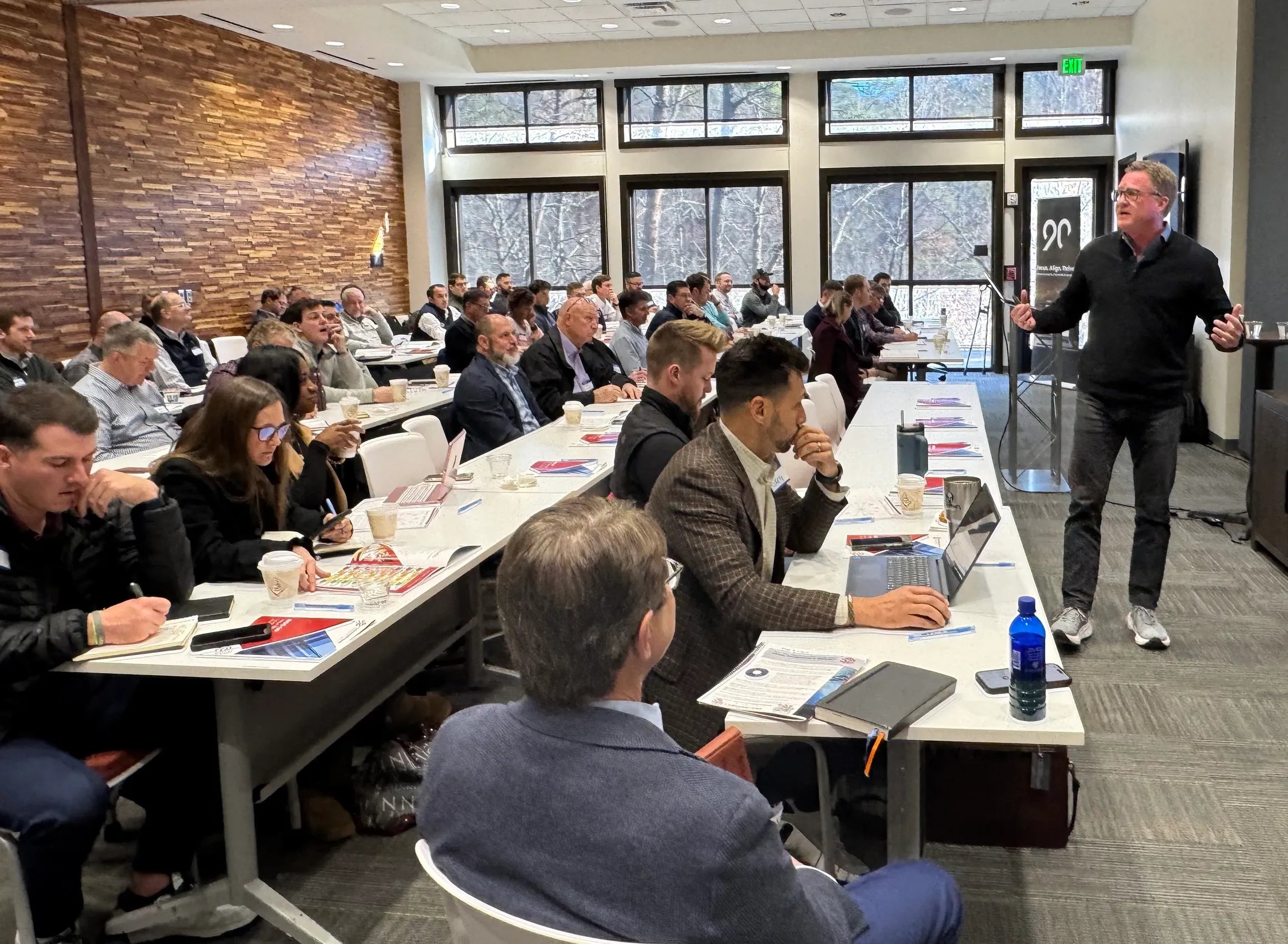 Scott Abbott speaking to a large audience at a conference