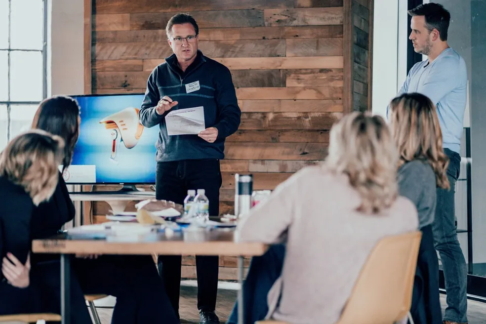 Scott Abbott presenting to a team in a workshop setting